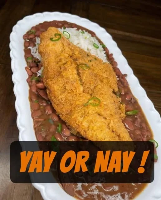 Plate of fried catfish served with red beans and rice