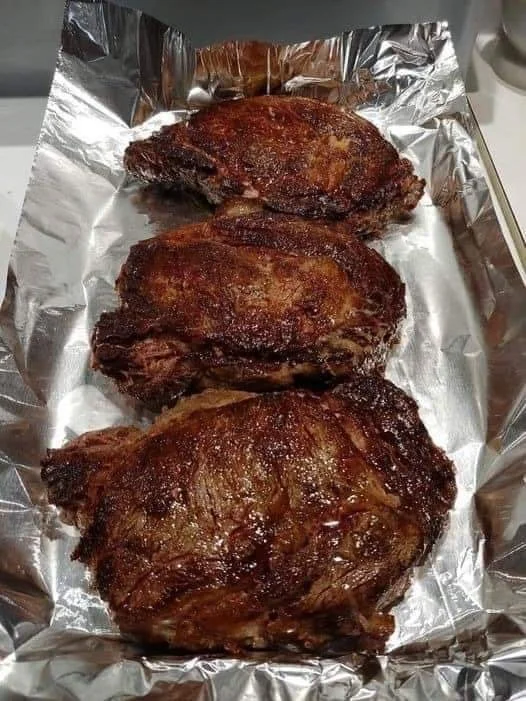 Delicious ribeye steaks grilled to perfection on a barbecue